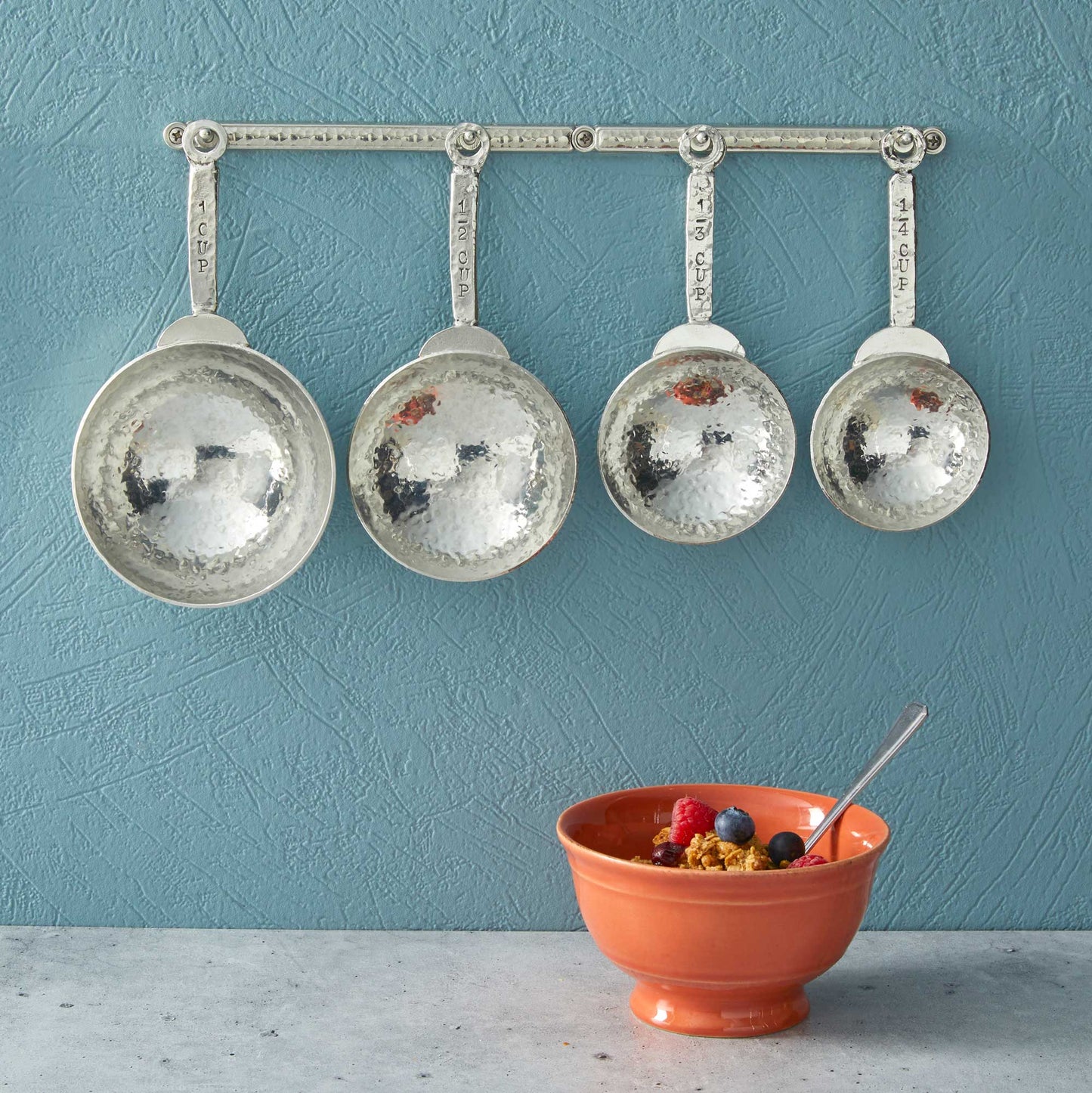 pewter homestead measuring cups on wall strip