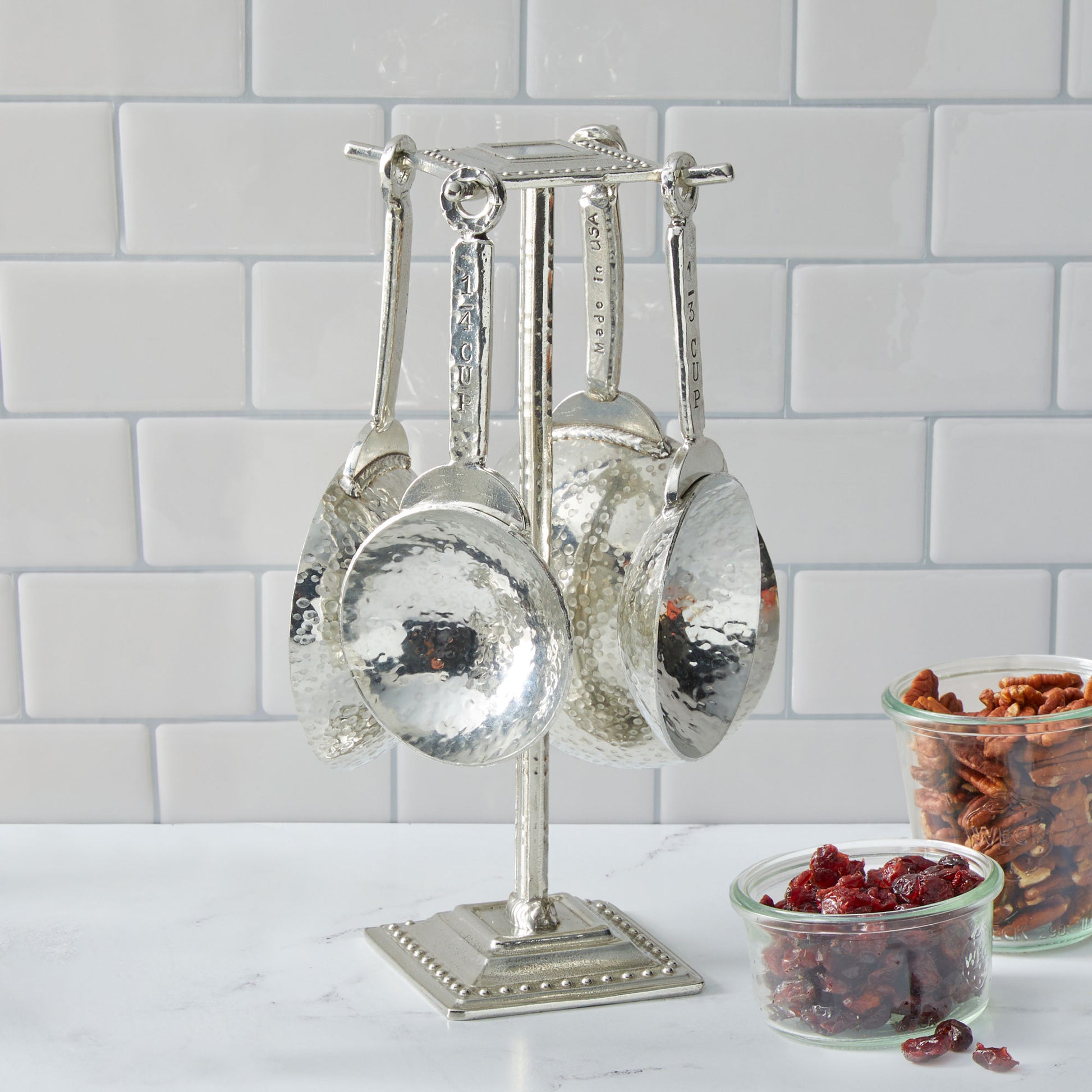 pewter homestead measuring cups on counter post
