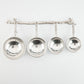 pewter twig measuring cups on wall strip