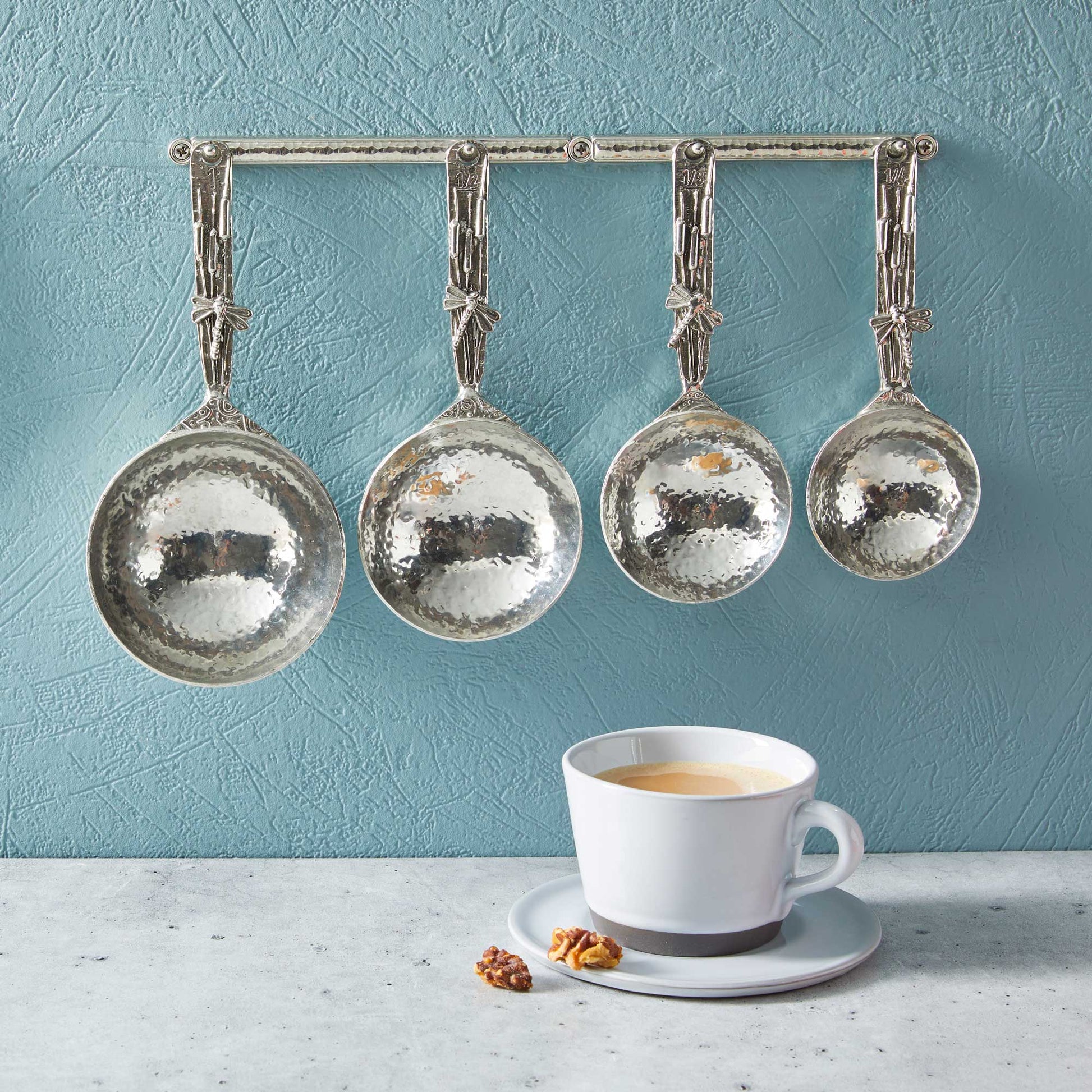 pewter dragonfly measuring cups on wall strip