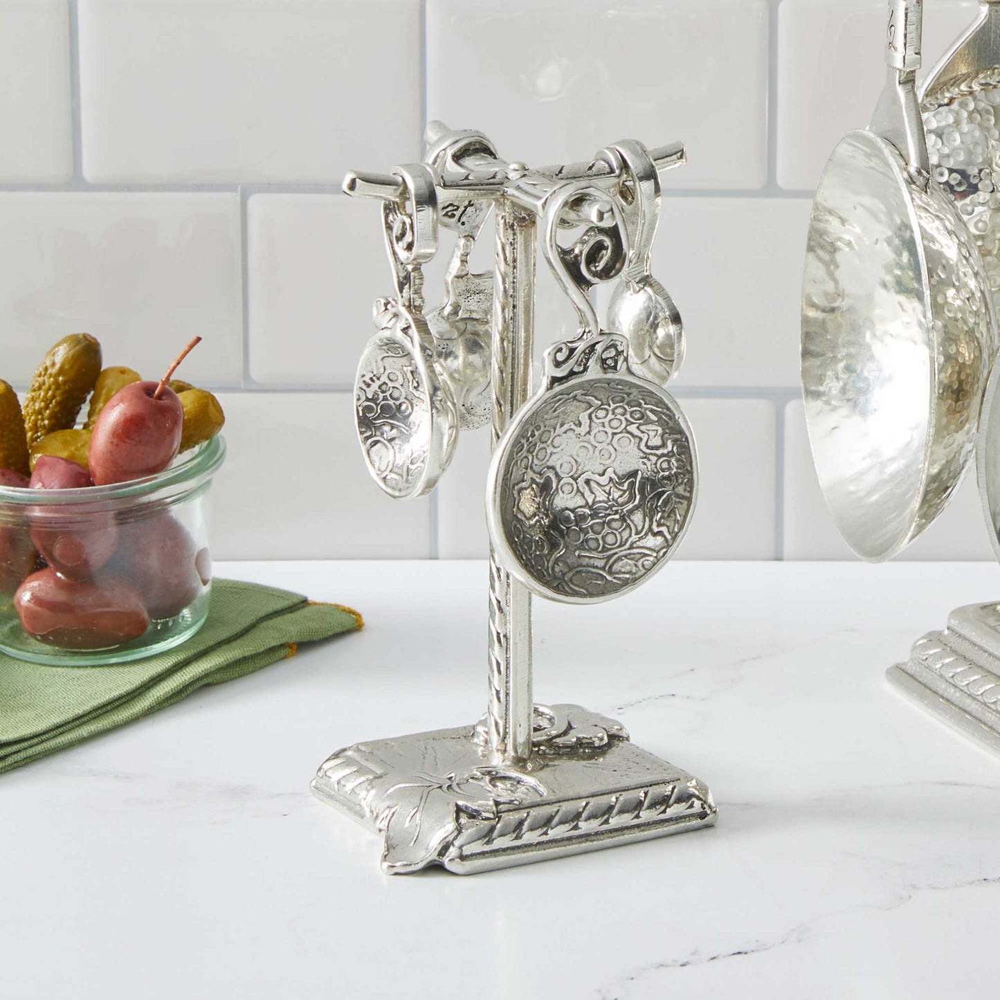 pewter vineyard measuring spoons on counter post