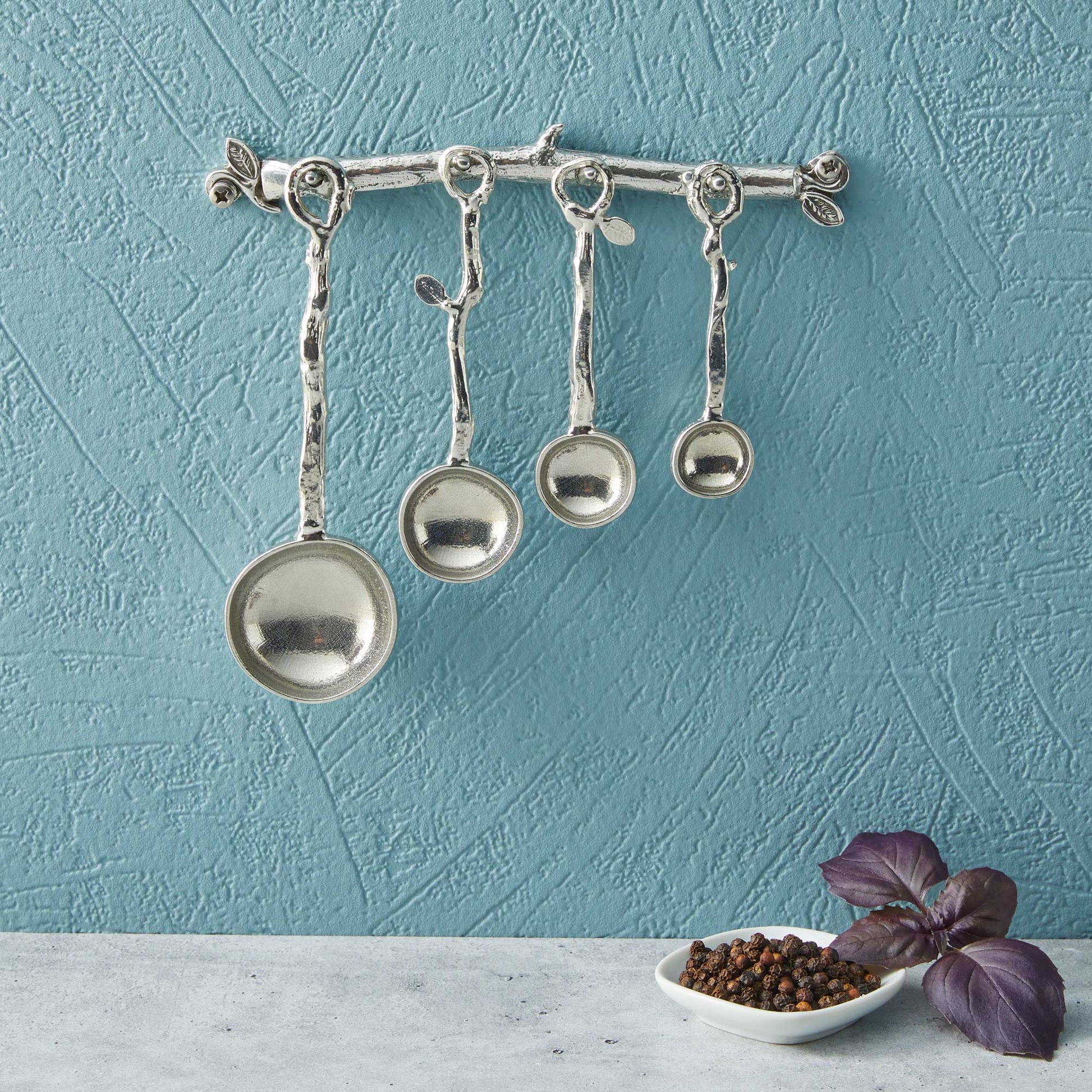 pewter twig measuring spoons on wall strip