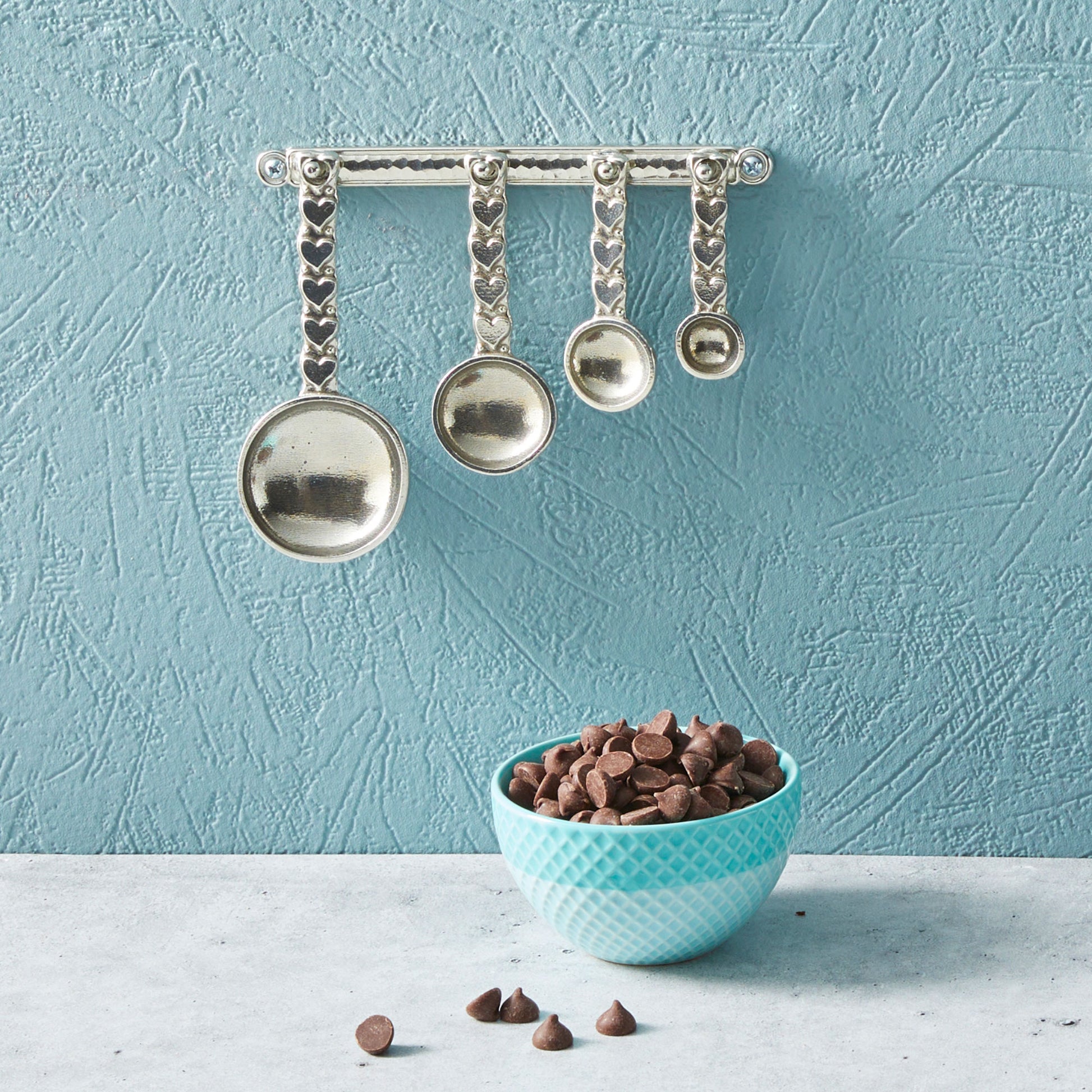 pewter heart measuring spoons on wall strip