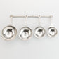 pewter homestead measuring cups on wall strip