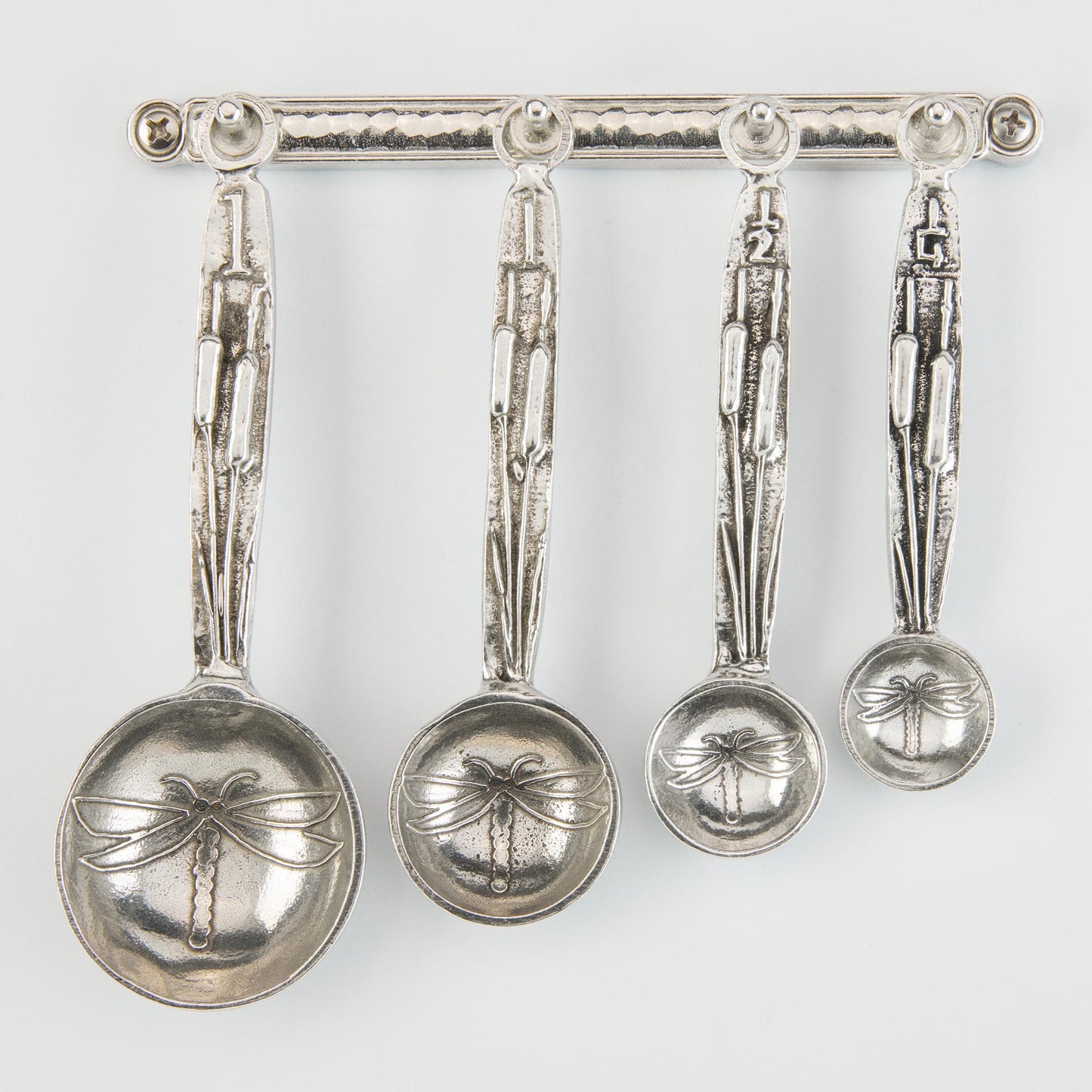 pewter dragonfly measuring spoons on wall strip